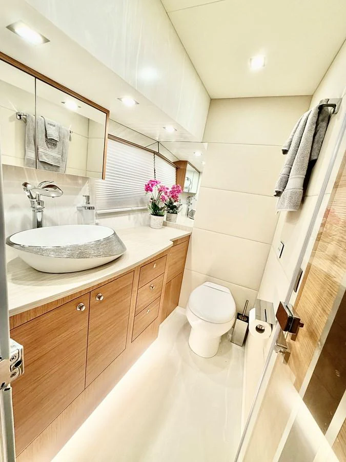 a bathroom with a sink toilet and a mirror aboard SEA AT LAST Yacht for Sale