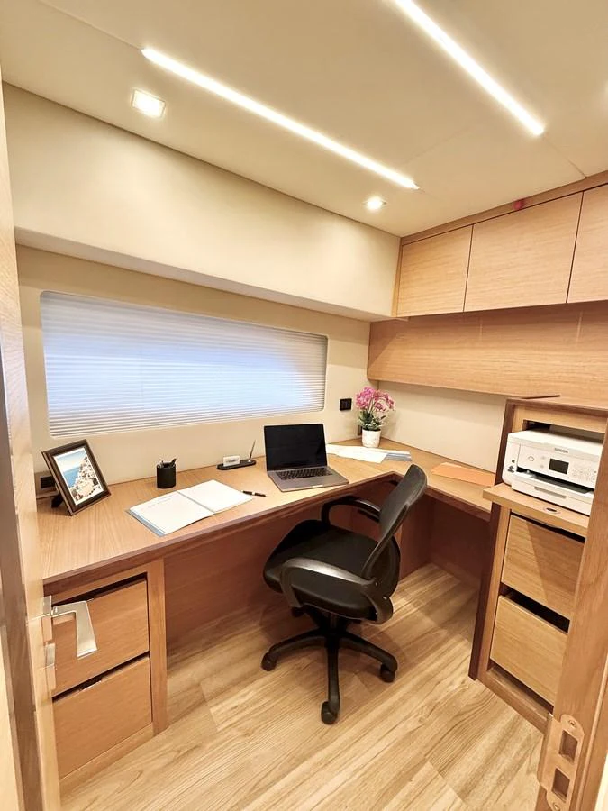 a room with a desk and a computer aboard SEA AT LAST Yacht for Sale