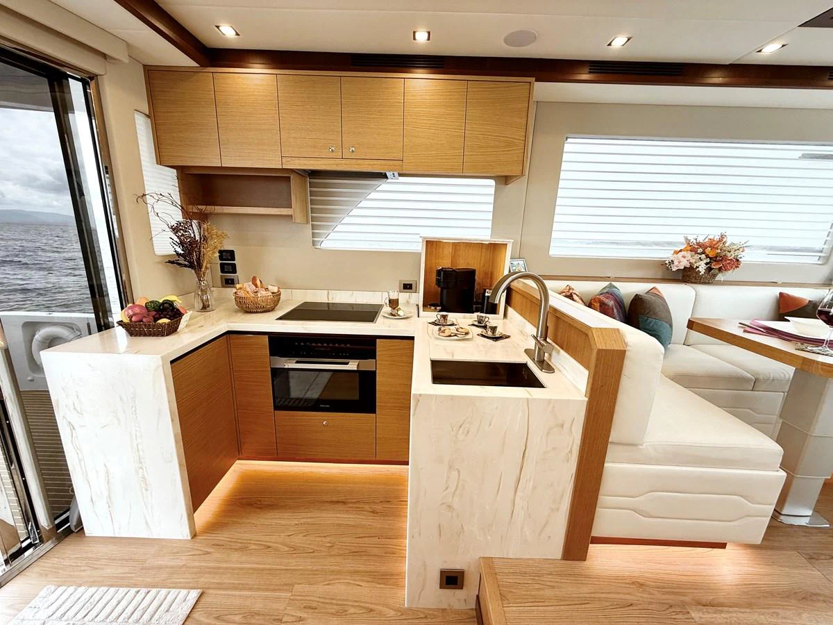 a kitchen with wooden cabinets aboard SEA AT LAST Yacht for Sale