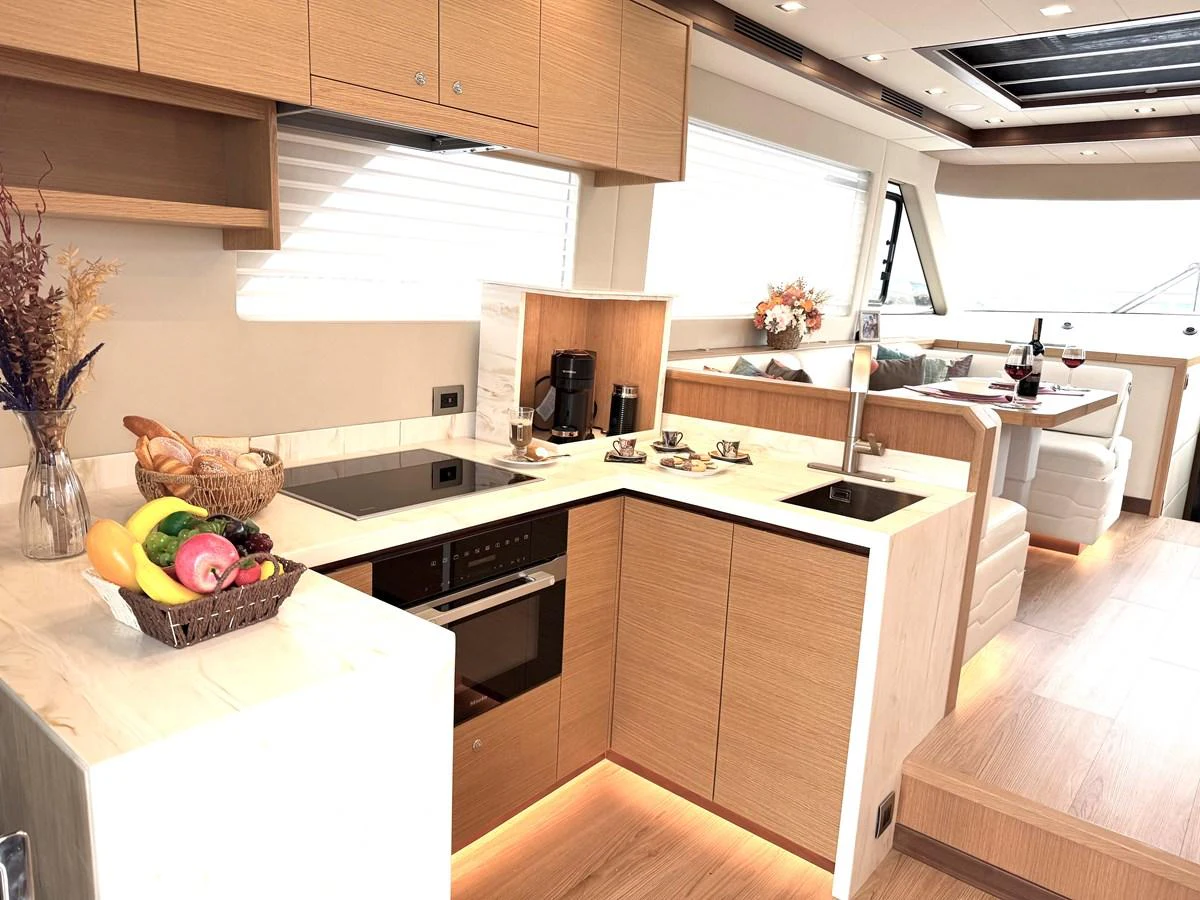a kitchen with a large island aboard SEA AT LAST Yacht for Sale