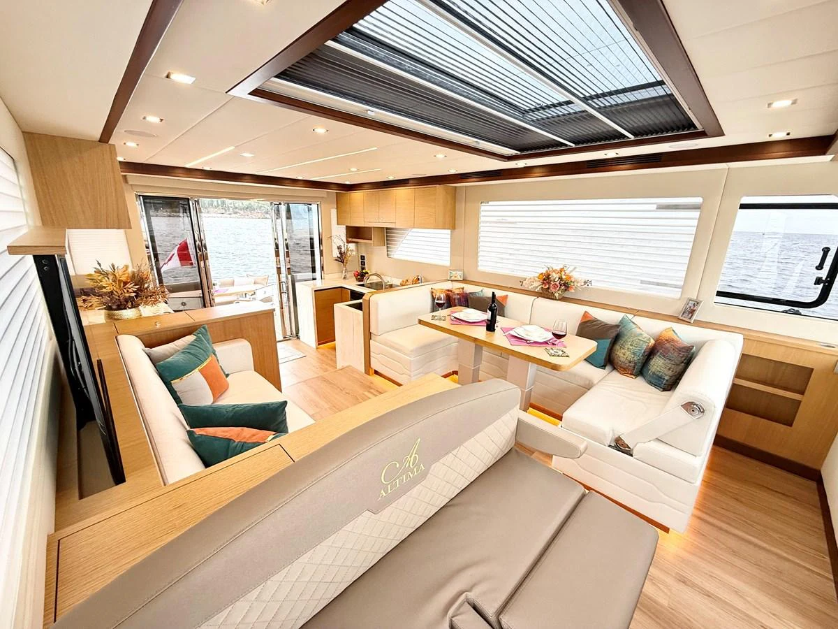 a living room with a large window aboard SEA AT LAST Yacht for Sale