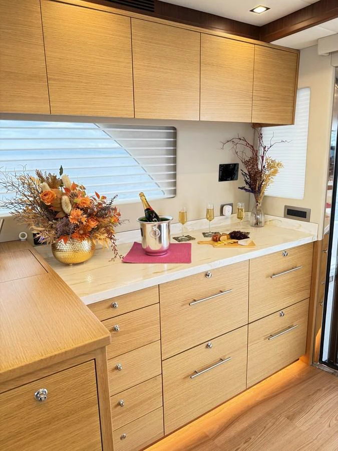 a kitchen with wooden cabinets aboard SEA AT LAST Yacht for Sale