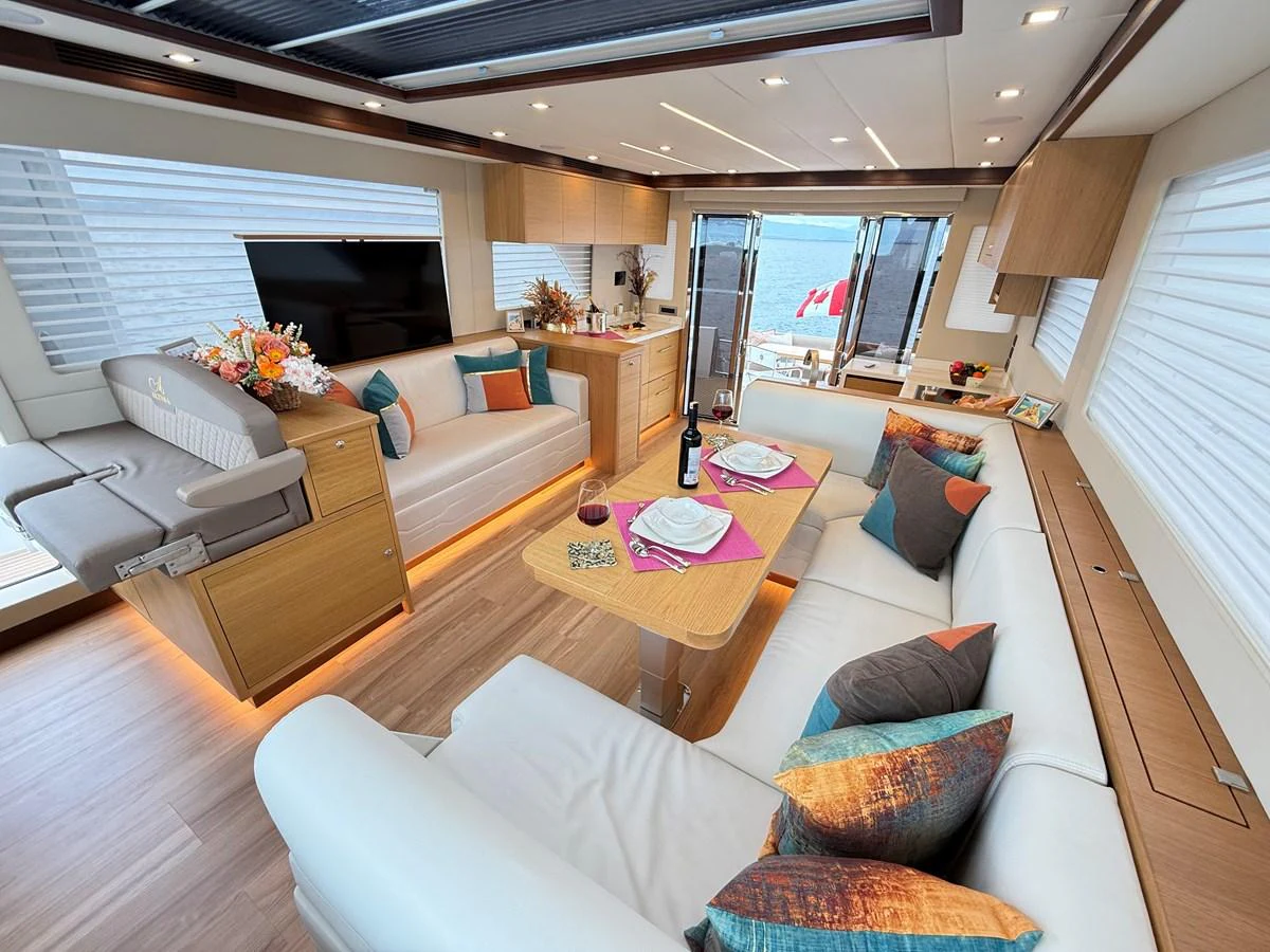 a living room with a large window aboard SEA AT LAST Yacht for Sale