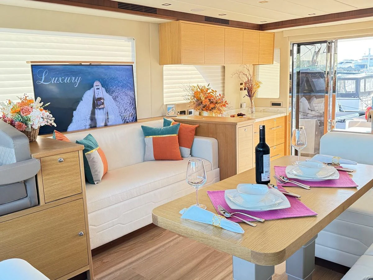 a living room with a table and a couch aboard SEA AT LAST Yacht for Sale