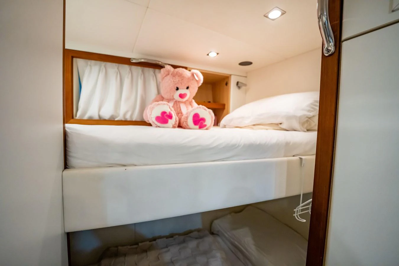a stuffed animal on a bed aboard PRECIOSO Yacht for Sale