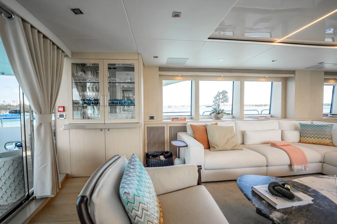 a living room with a couch and a table aboard PRECIOSO Yacht for Sale
