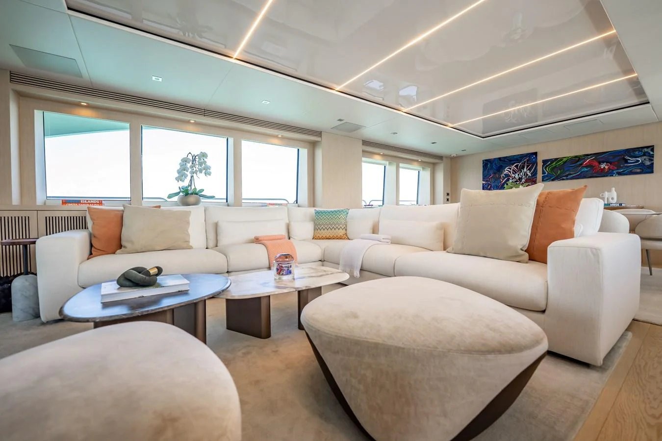 a living room with white couches aboard PRECIOSO Yacht for Sale