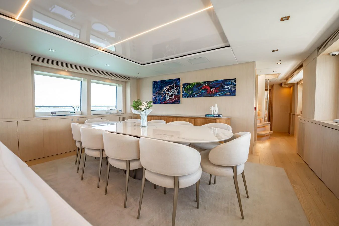 a large white table with chairs around it aboard PRECIOSO Yacht for Sale