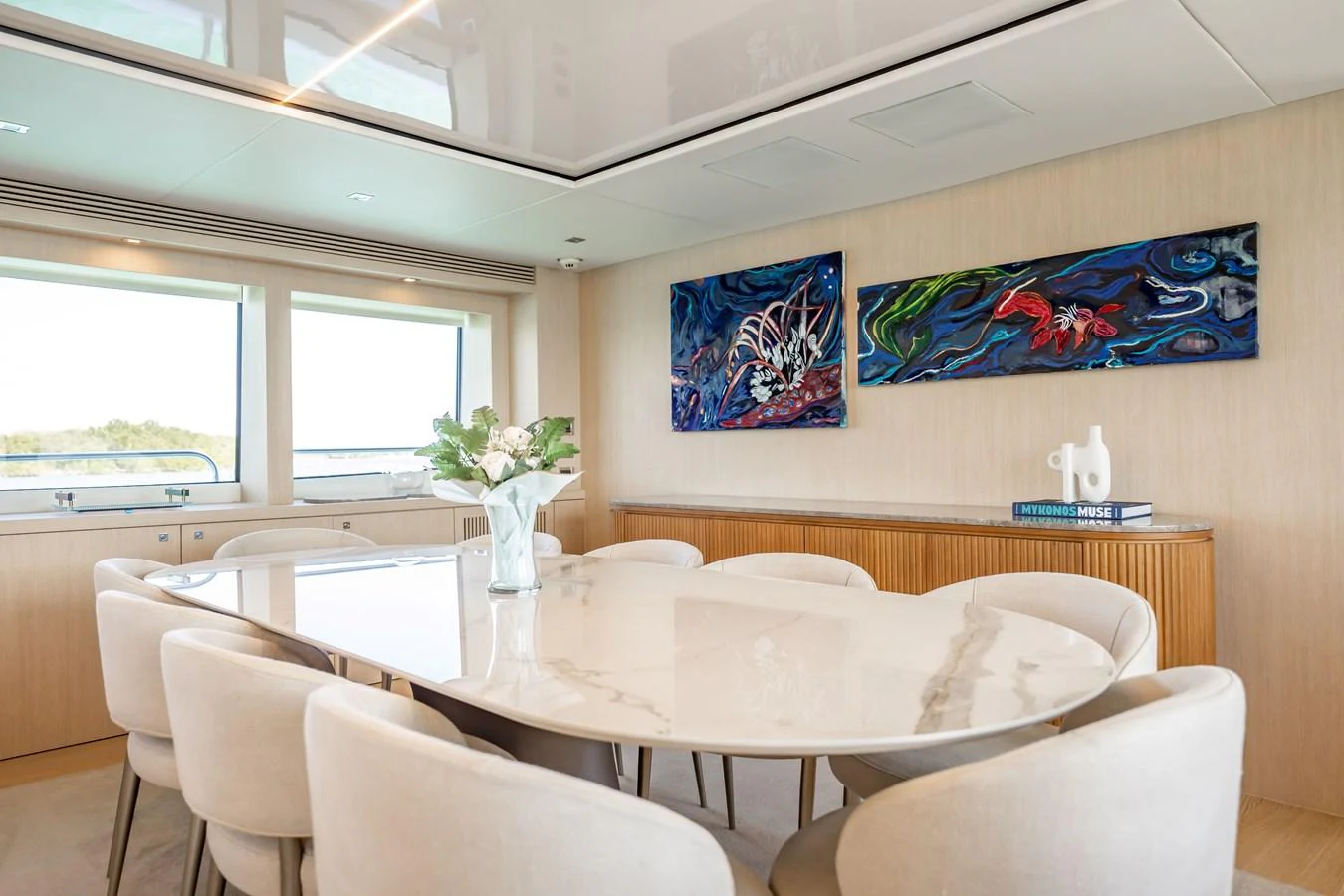 a room with tables and chairs aboard PRECIOSO Yacht for Sale