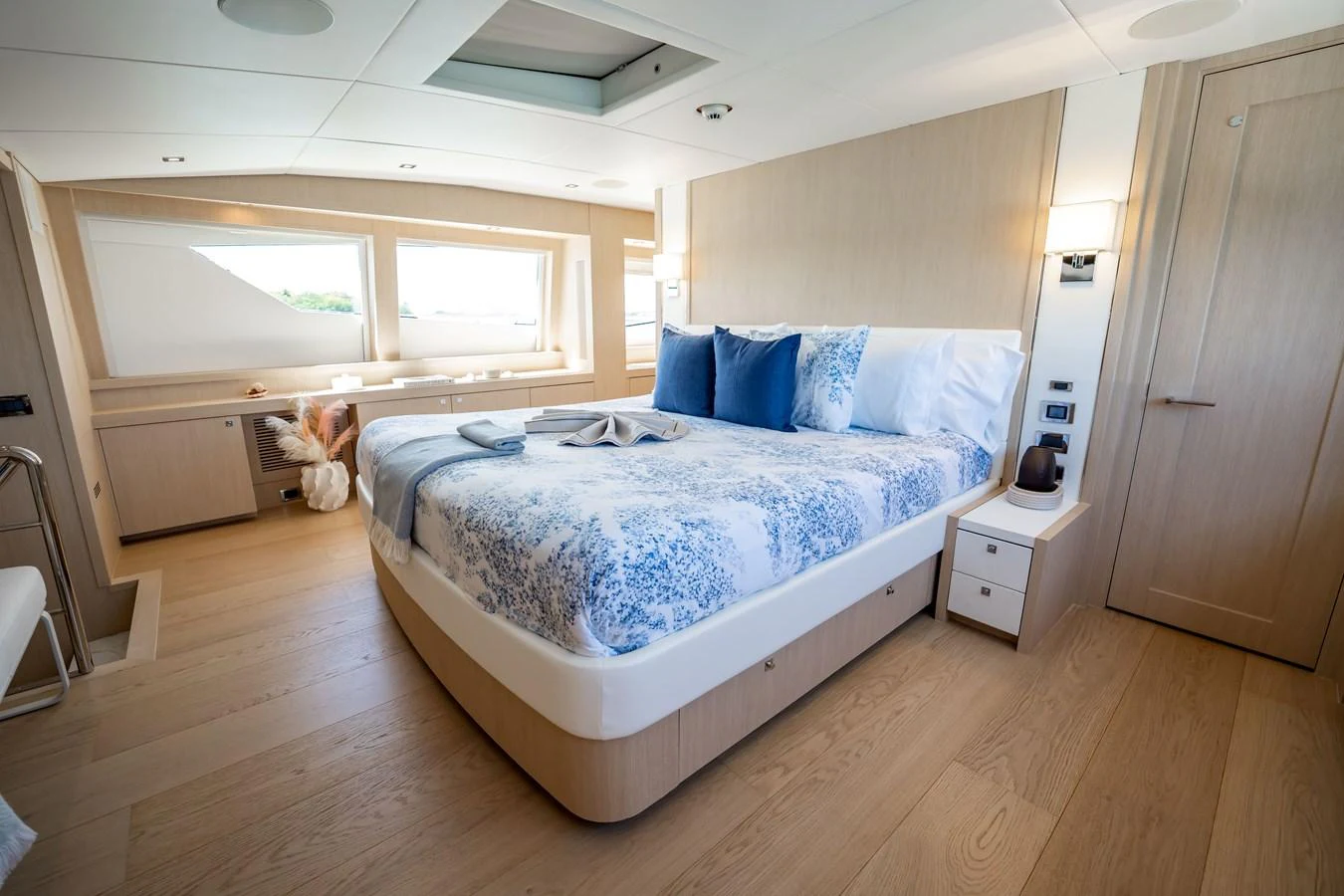 a bedroom with a bed and a cat on the bed aboard PRECIOSO Yacht for Sale