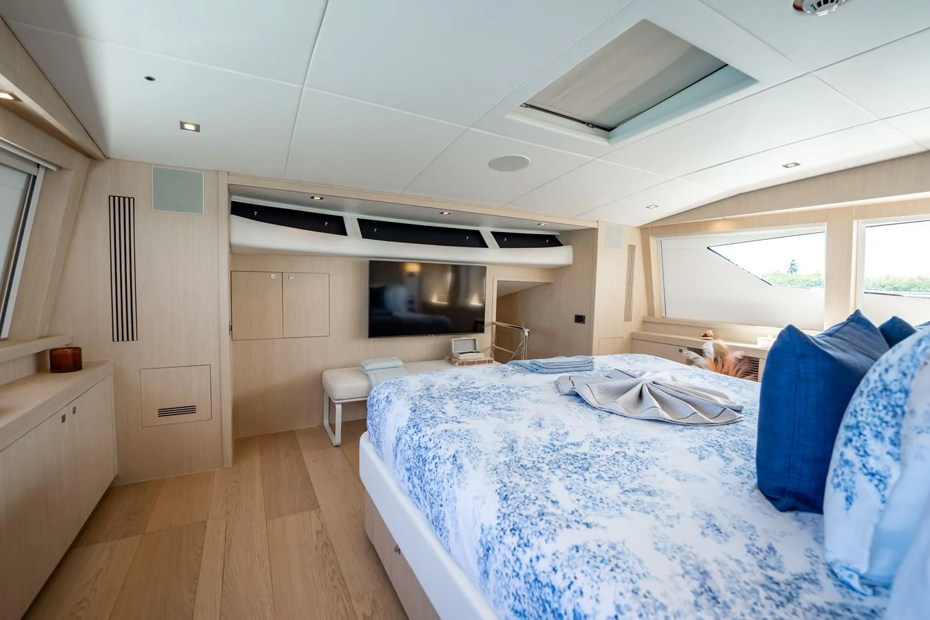 a bedroom with a bed and a television aboard PRECIOSO Yacht for Sale