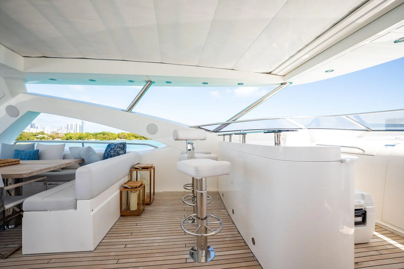 a room with a large white sofa and a table and a large window aboard PRECIOSO Yacht for Sale