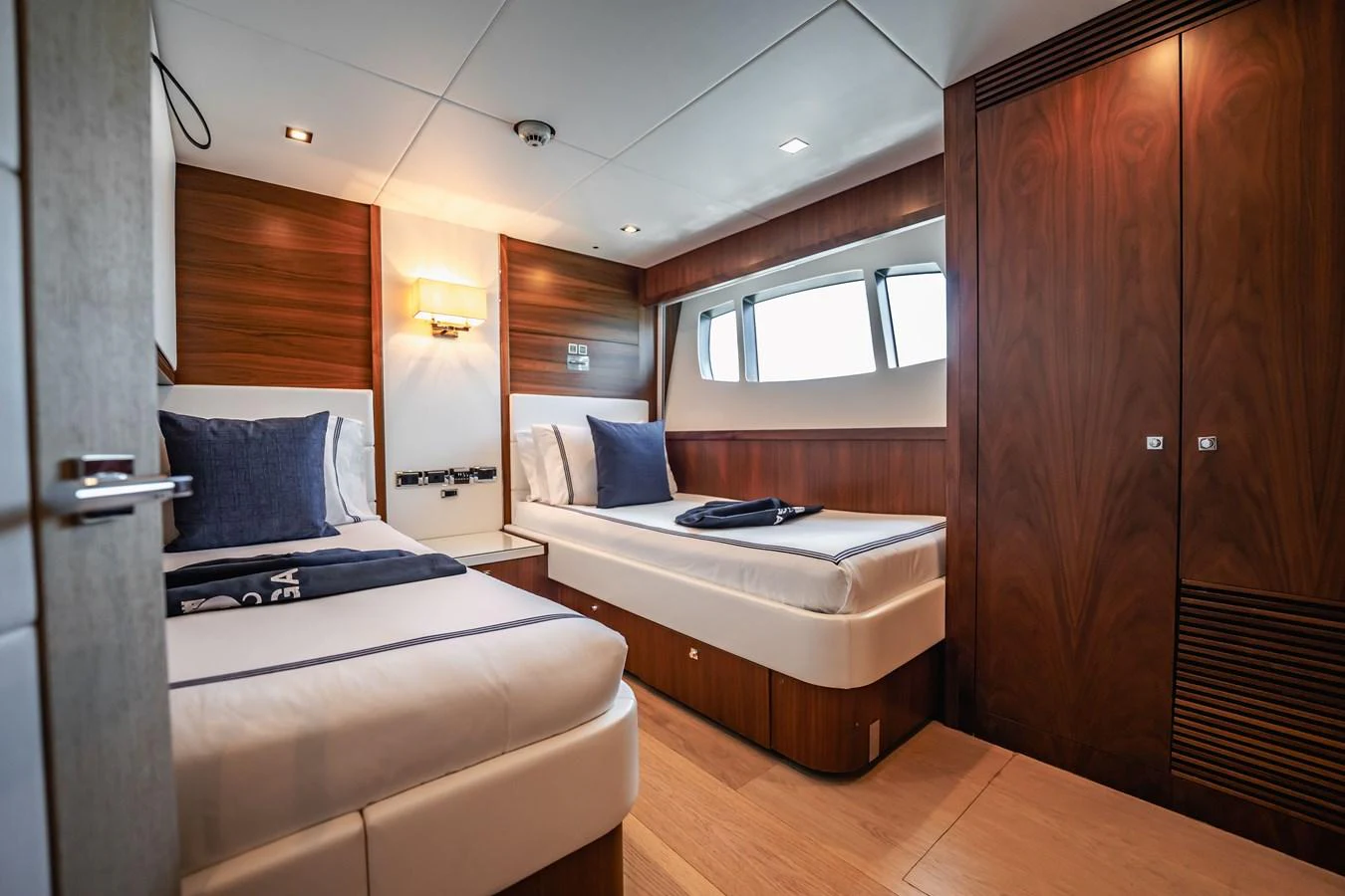 a bedroom with a bed and a desk aboard PRECIOSO Yacht for Sale