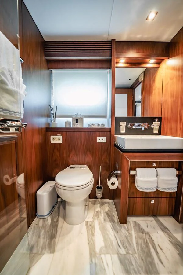 a bathroom with wooden walls aboard PRECIOSO Yacht for Sale