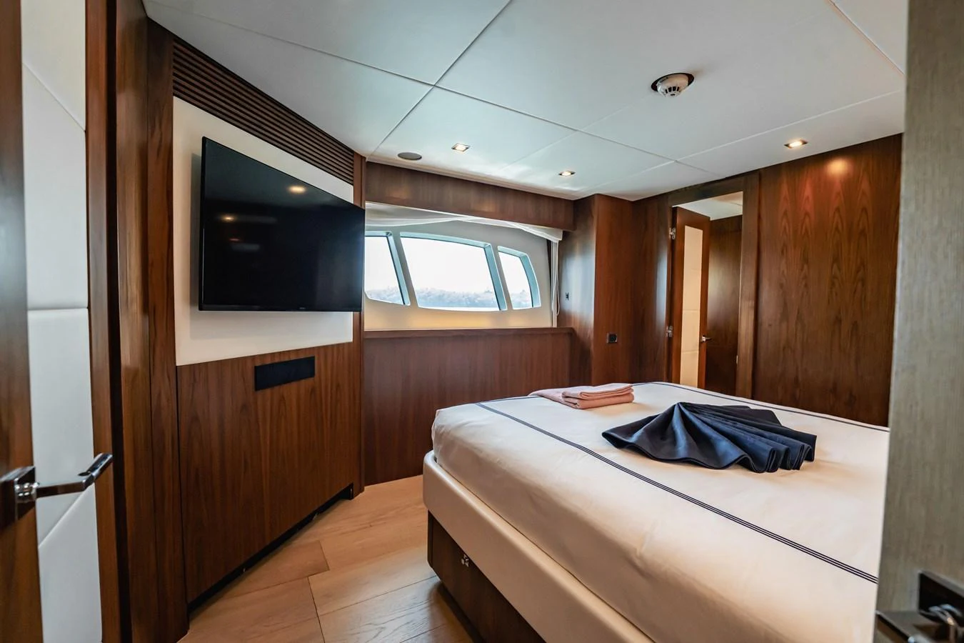 a room with a bed and a television aboard PRECIOSO Yacht for Sale