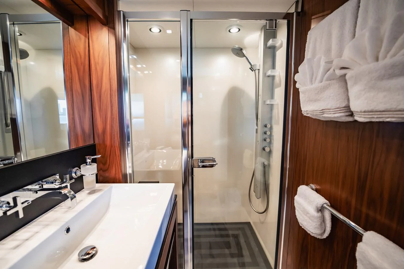 a bathroom with a shower and sink aboard PRECIOSO Yacht for Sale