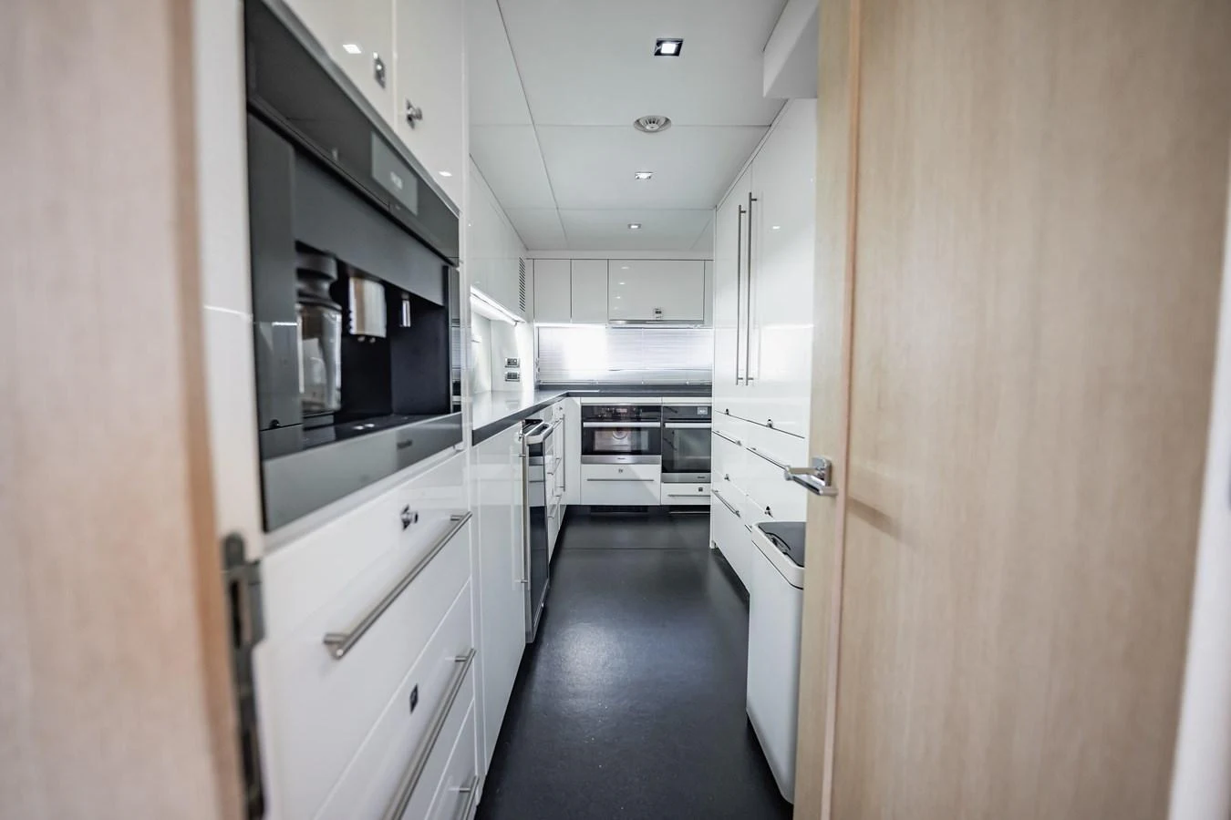 a hallway with white cabinets aboard PRECIOSO Yacht for Sale