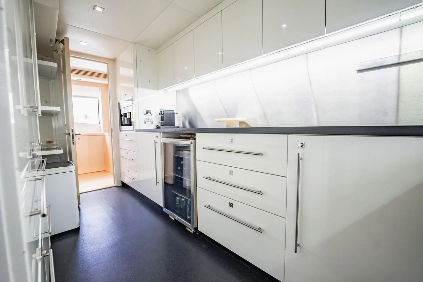 a kitchen with white cabinets aboard PRECIOSO Yacht for Sale