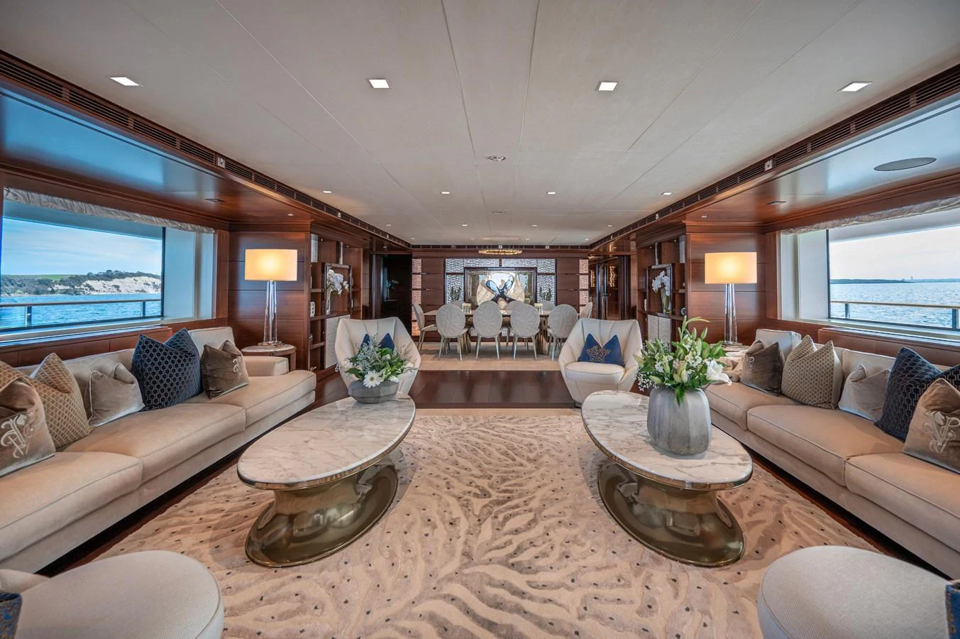 a living room with a large sofa and a coffee table aboard ODYSSEY Yacht for Sale