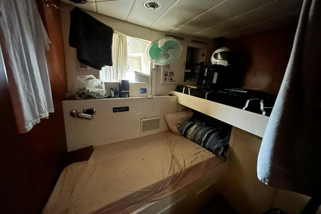 a bedroom with a bed and a desk aboard SUNSHINE Yacht for Sale
