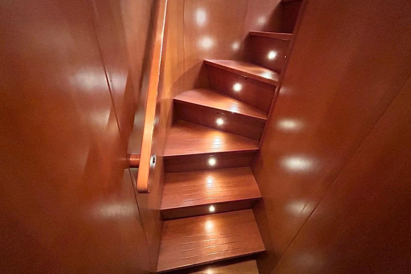 a wooden staircase with a glass railing aboard SUNSHINE Yacht for Sale