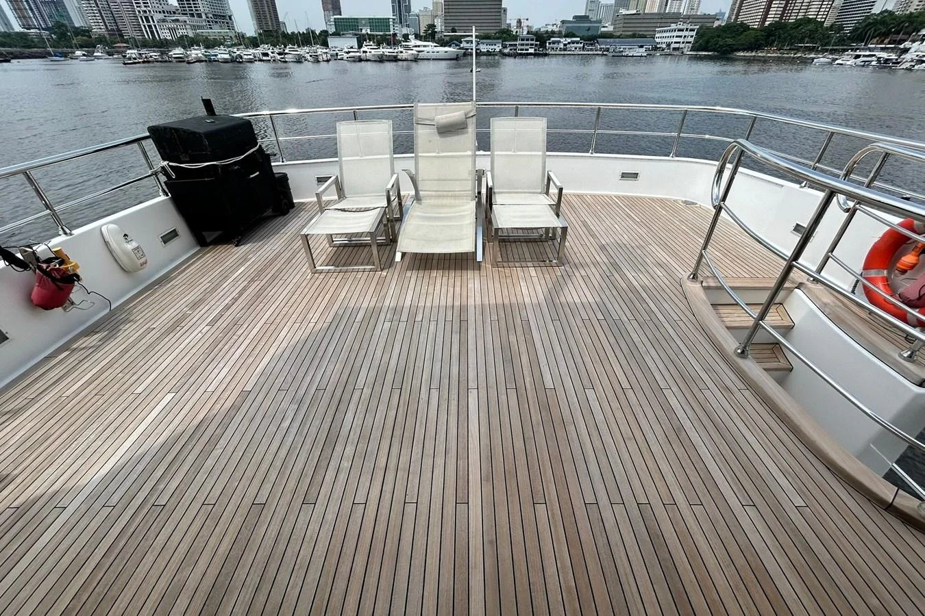 a deck with chairs on it by a body of water aboard SUNSHINE Yacht for Sale