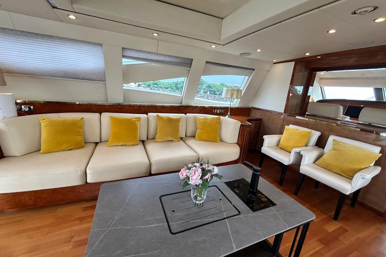 a living room with a table and couches aboard SUNSHINE Yacht for Sale
