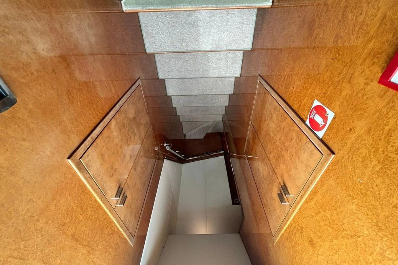 a wooden cabinet with a red logo on it aboard SUNSHINE Yacht for Sale