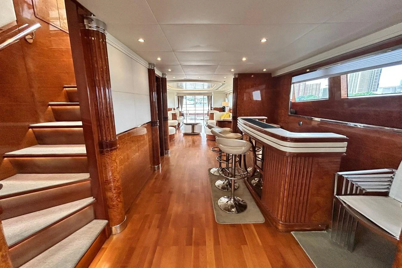 a room with a wood floor and a table and chairs aboard SUNSHINE Yacht for Sale