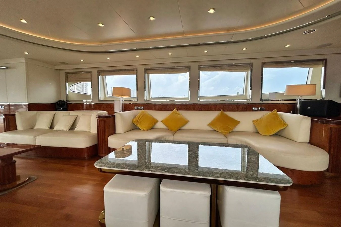 a living room with a large glass coffee table aboard SUNSHINE Yacht for Sale