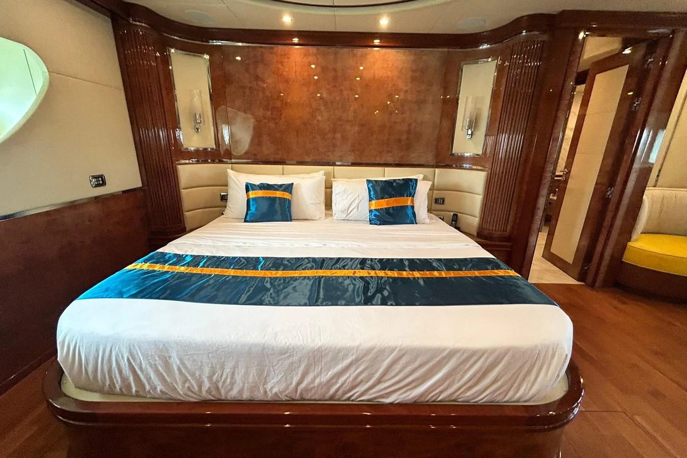 a bed with blue and white sheets aboard SUNSHINE Yacht for Sale