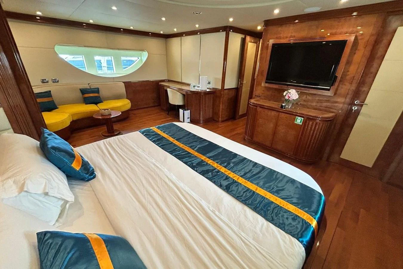 a bedroom with a bed and a tv aboard SUNSHINE Yacht for Sale