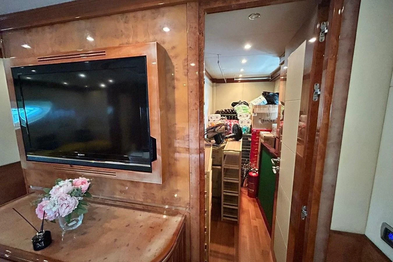 a room with a tv and flowers aboard SUNSHINE Yacht for Sale