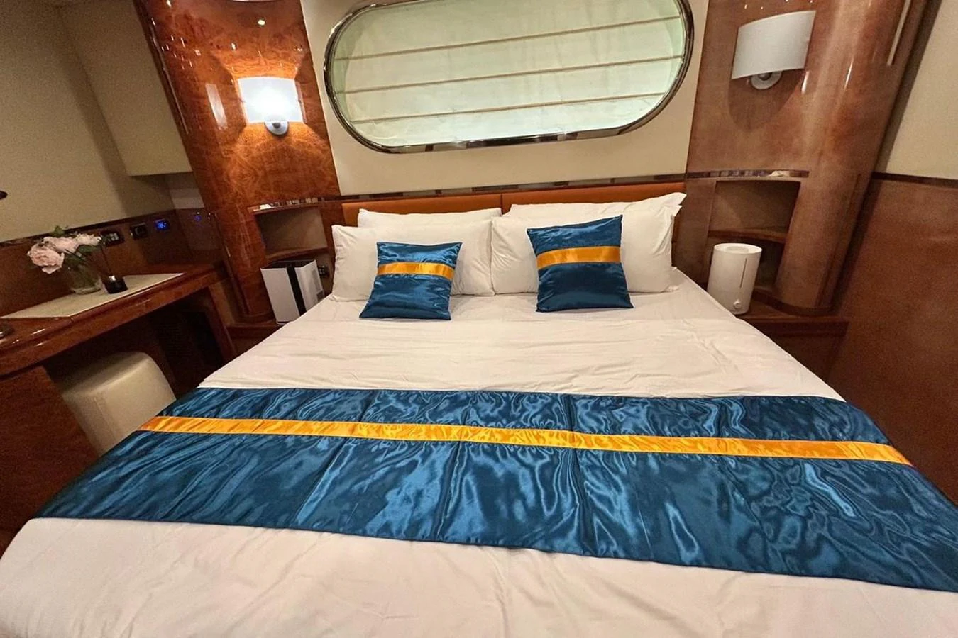 a bed with blue and yellow pillows aboard SUNSHINE Yacht for Sale