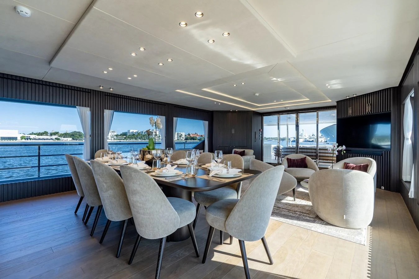 a large room with a table and chairs aboard RESONANCE Yacht for Sale