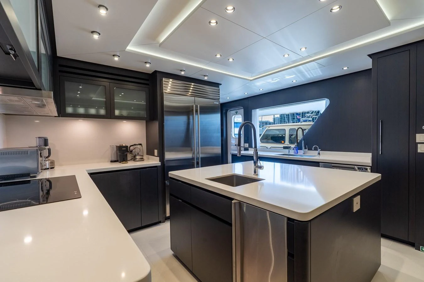 a kitchen with black cabinets aboard RESONANCE Yacht for Sale