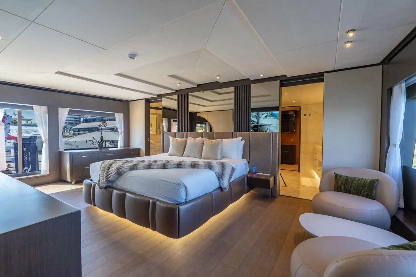 a large living room with a large bed and a large screen aboard RESONANCE Yacht for Sale