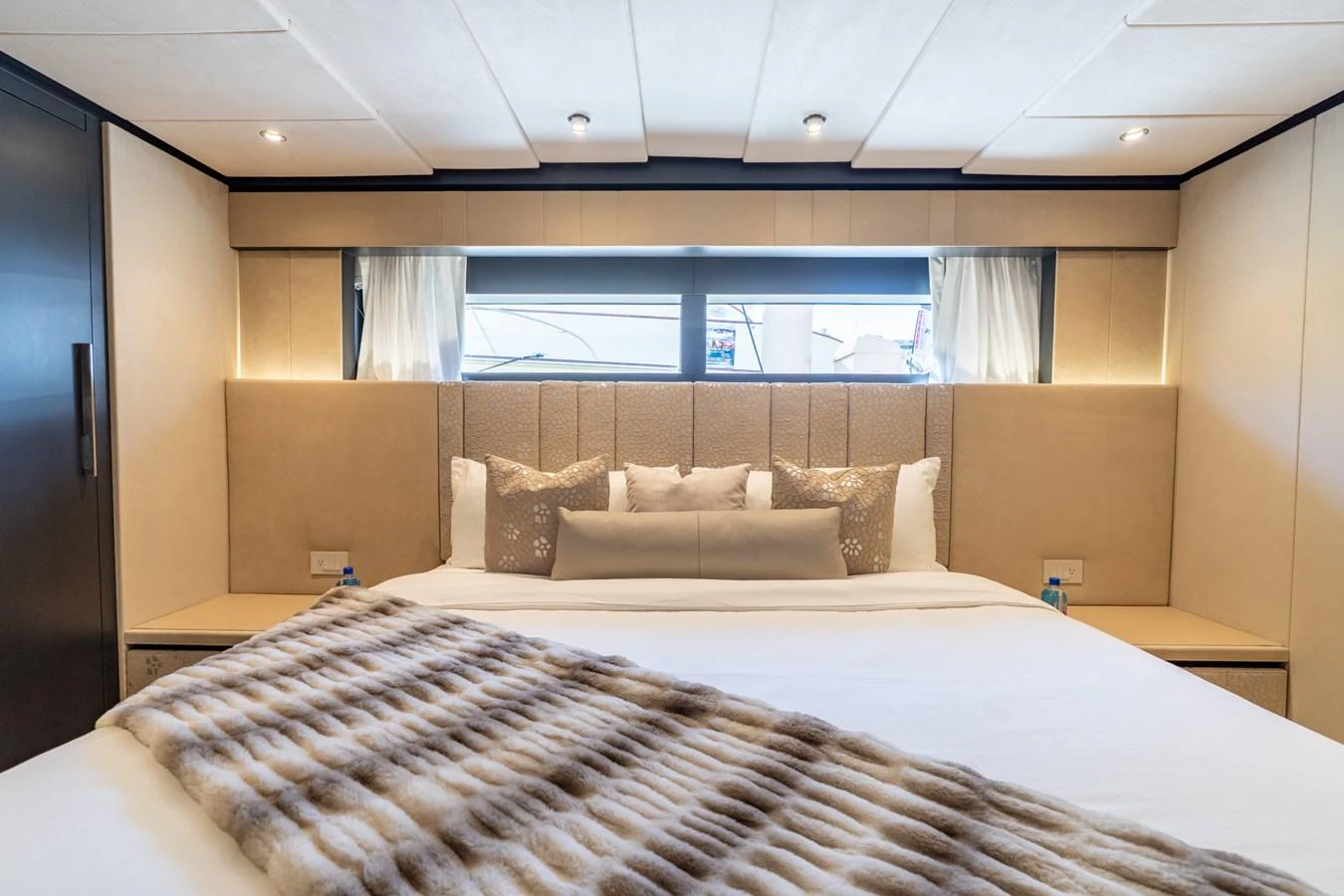 a bed with a white bed spread aboard RESONANCE Yacht for Sale