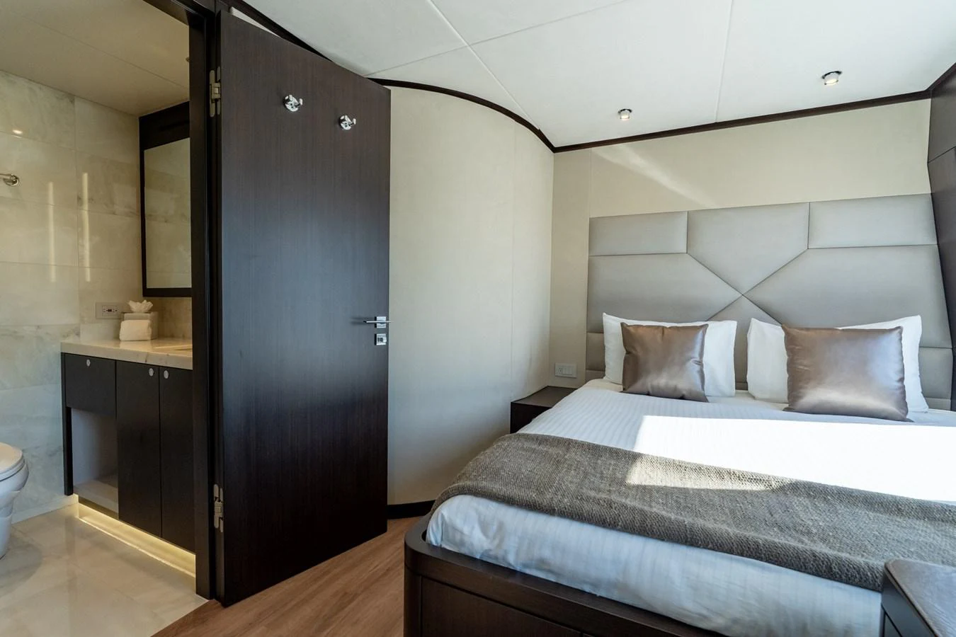 a bedroom with a bed and a closet aboard RESONANCE Yacht for Sale