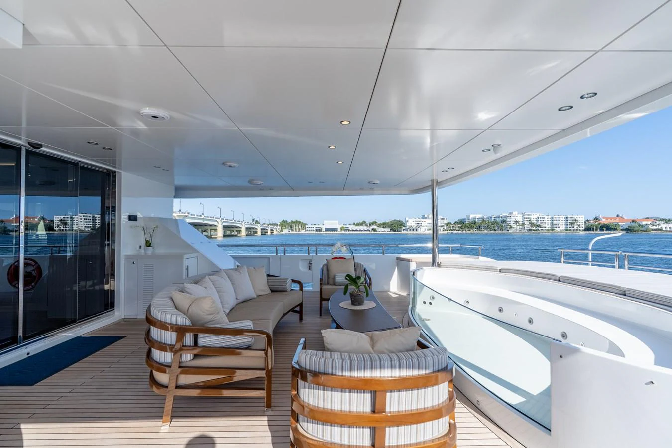 a large white bathtub in a room with a large window and a view of the water aboard RESONANCE Yacht for Sale