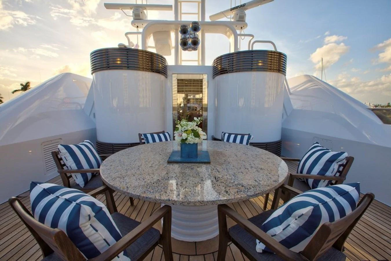 a table with chairs and a large white bucket on it aboard ALL STAR 1 Yacht for Sale
