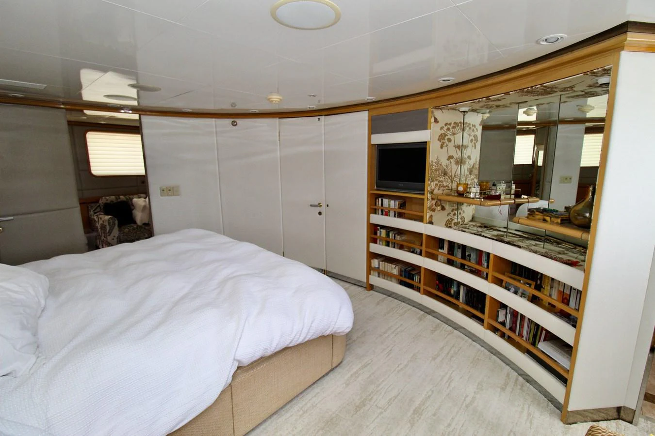 a bedroom with a large mirror aboard MAVERICK Yacht for Sale