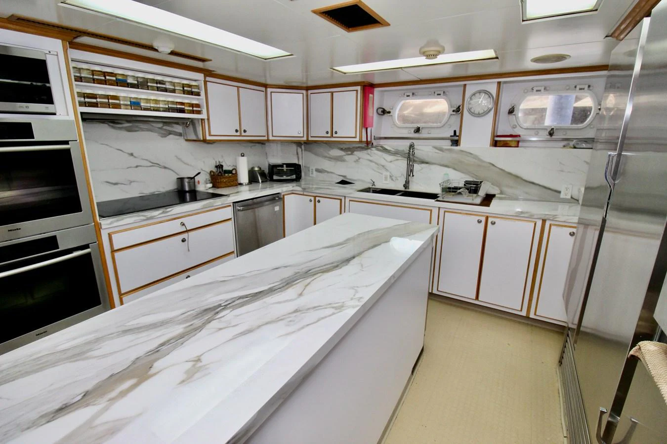 a kitchen with white cabinets aboard MAVERICK Yacht for Sale