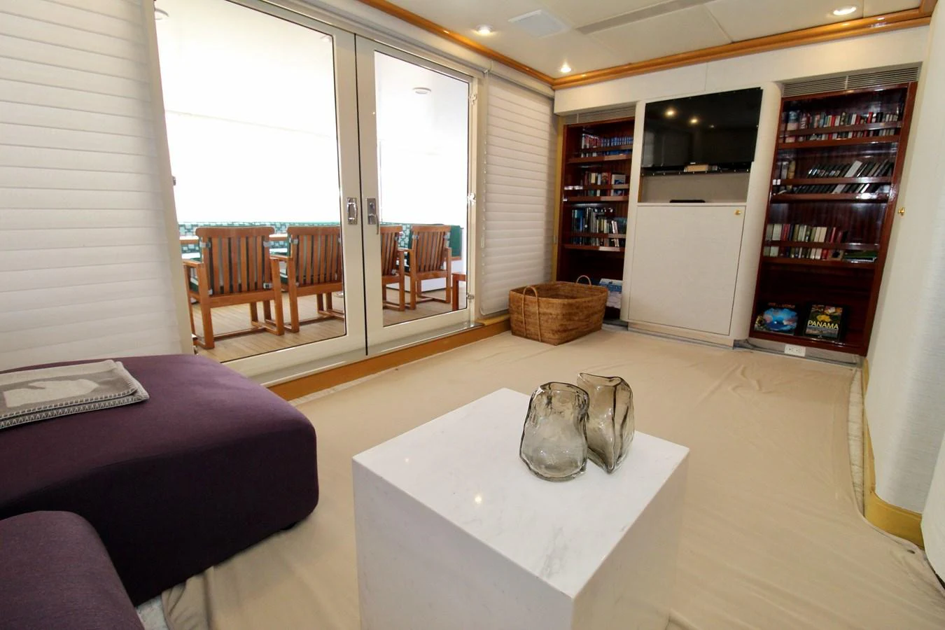 a living room with a table and chairs aboard MAVERICK Yacht for Sale