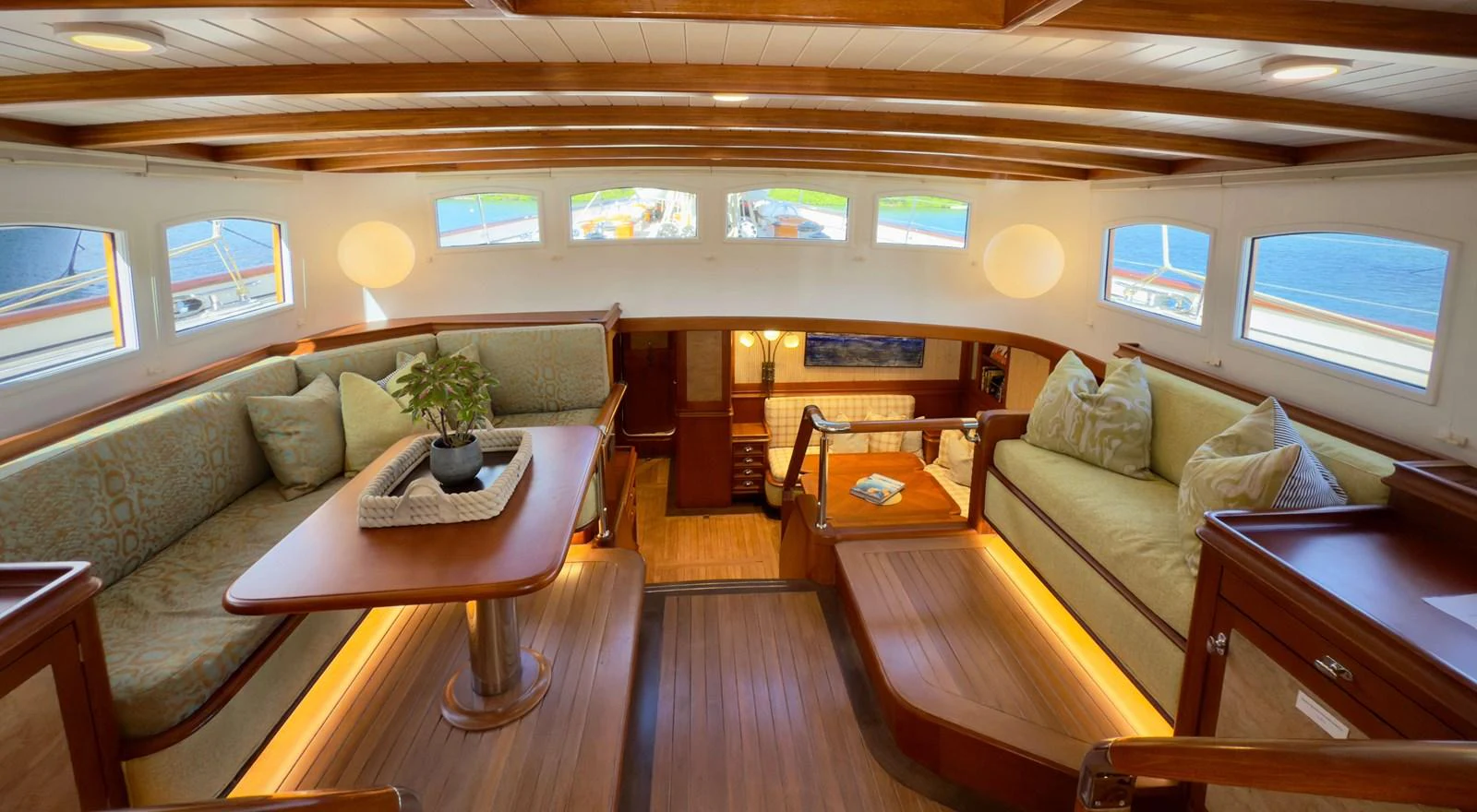 a living room with a couch and a coffee table aboard NAMUUN Yacht for Sale