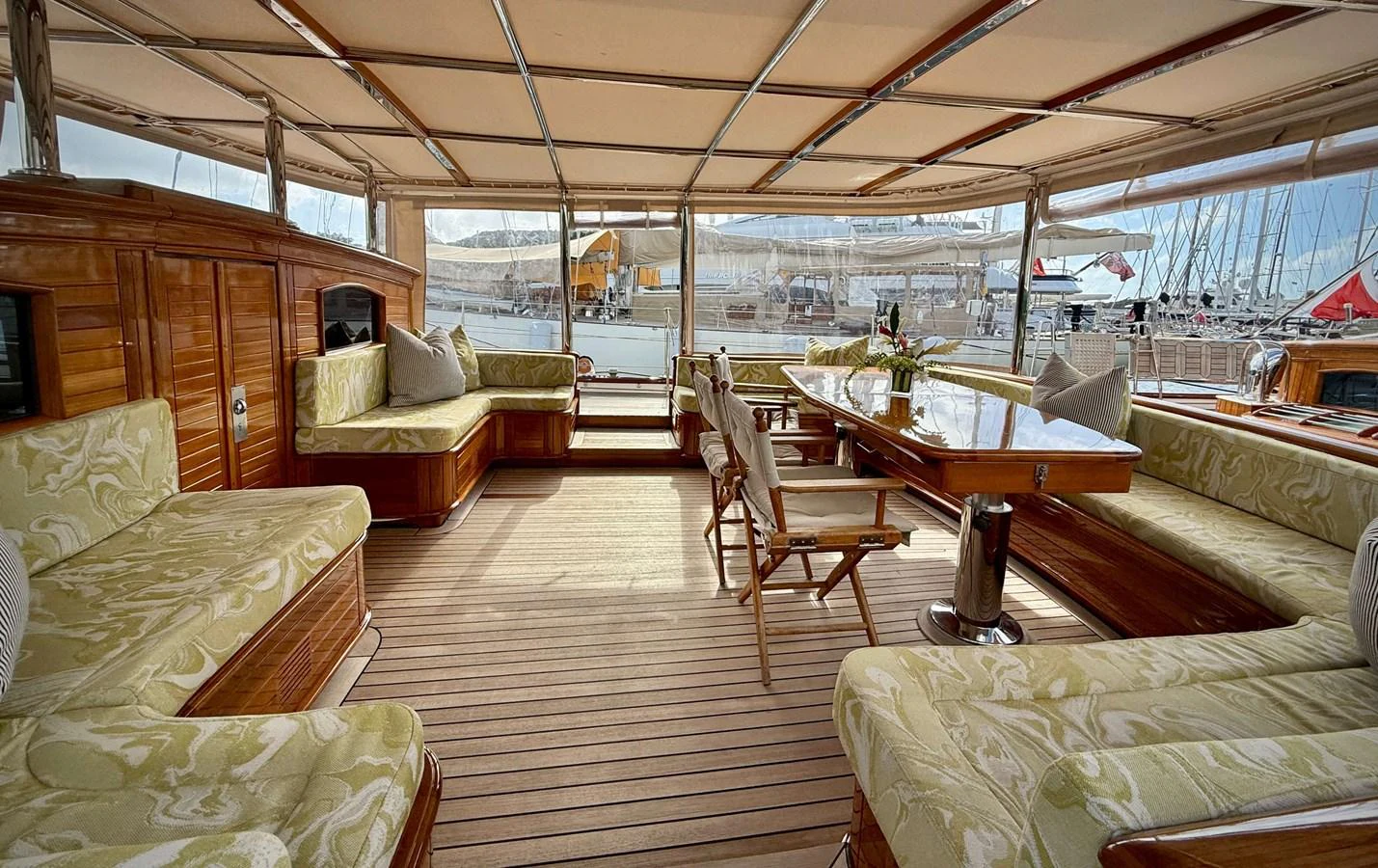 a room with a table chairs and a couch aboard NAMUUN Yacht for Sale