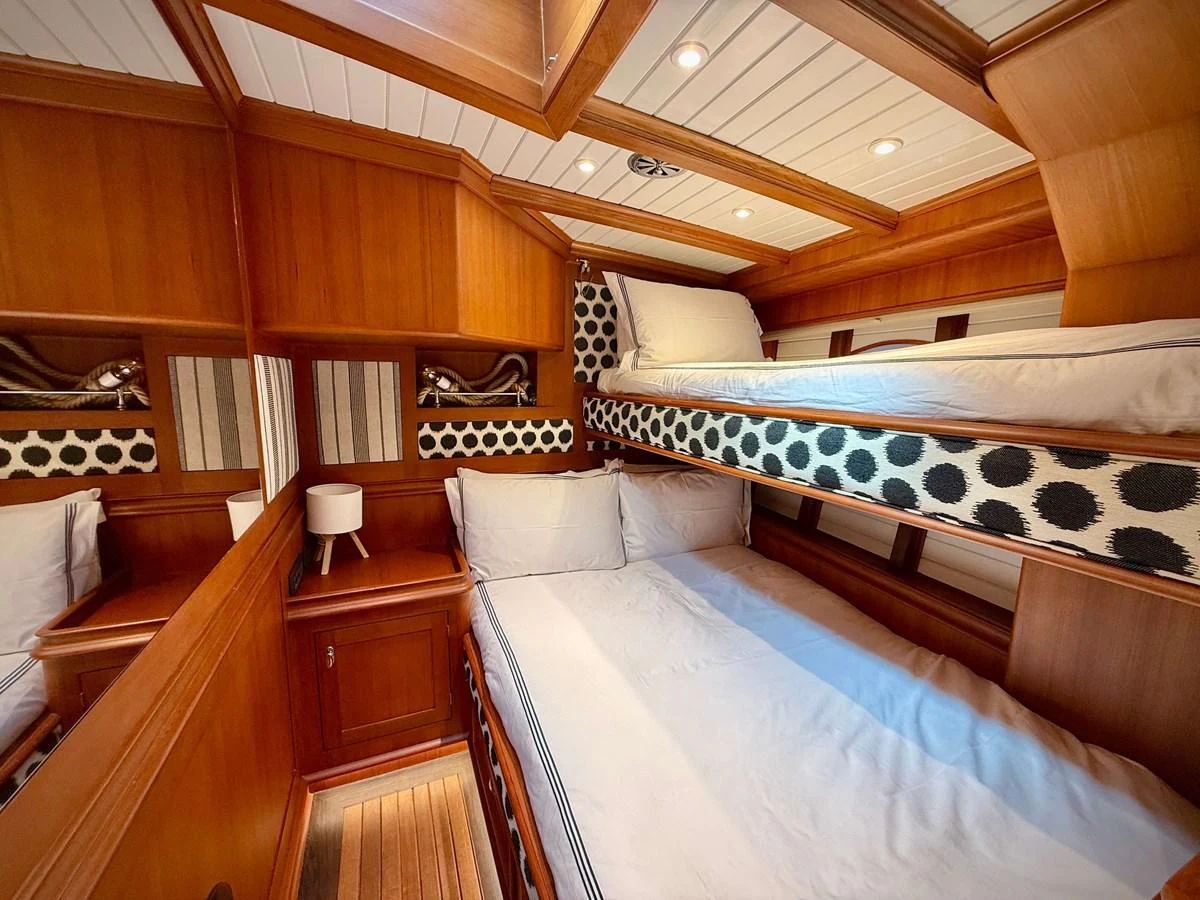 a room with a bed and a couch aboard NAMUUN Yacht for Sale