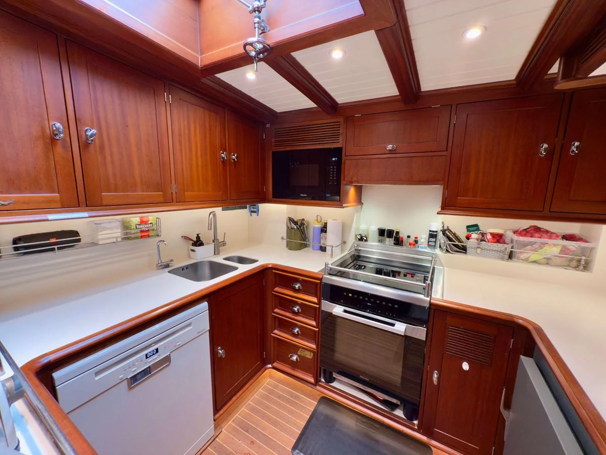a kitchen with wooden cabinets aboard NAMUUN Yacht for Sale