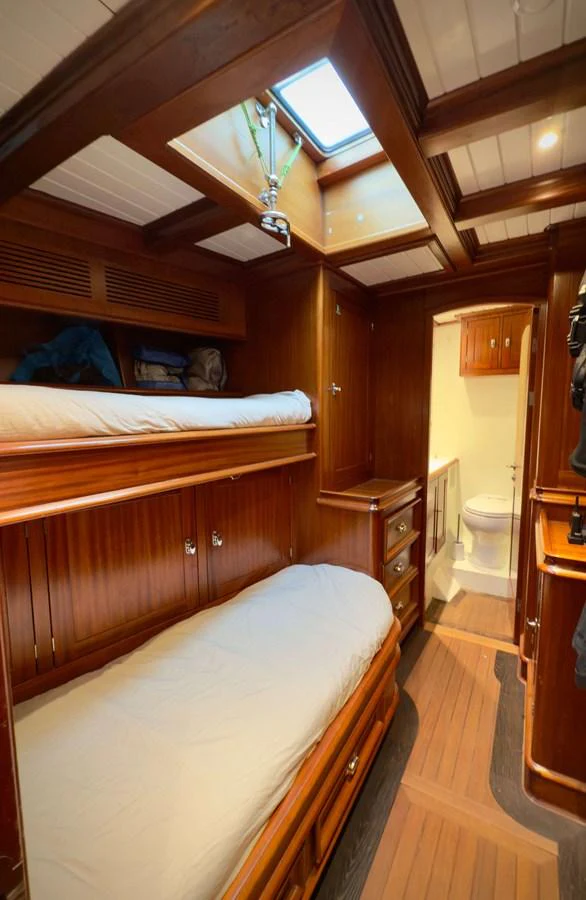 a bedroom with two beds aboard NAMUUN Yacht for Sale