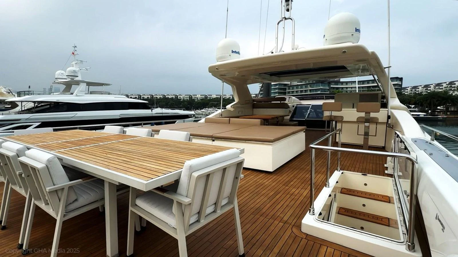 a deck with a table and chairs on it aboard OXYGEN Yacht for Sale